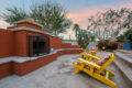 Outdoor wood burning fireplace and smoking area.