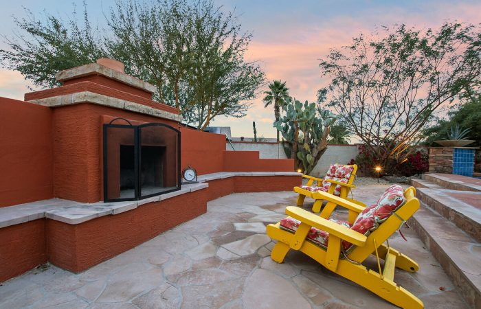 Outdoor wood burning fireplace and smoking area.